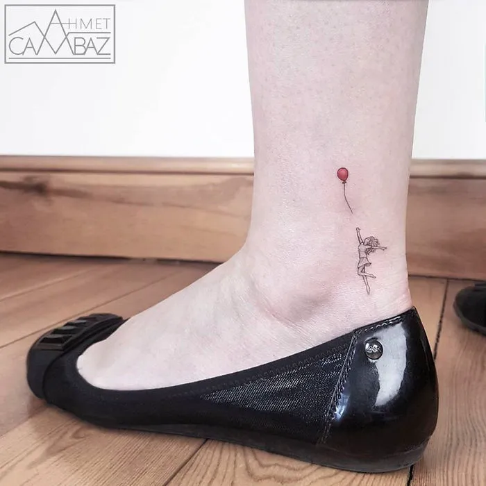 Minimalist tattoo by Turkish cartoonist on ankle, featuring a small figure holding a red balloon.
