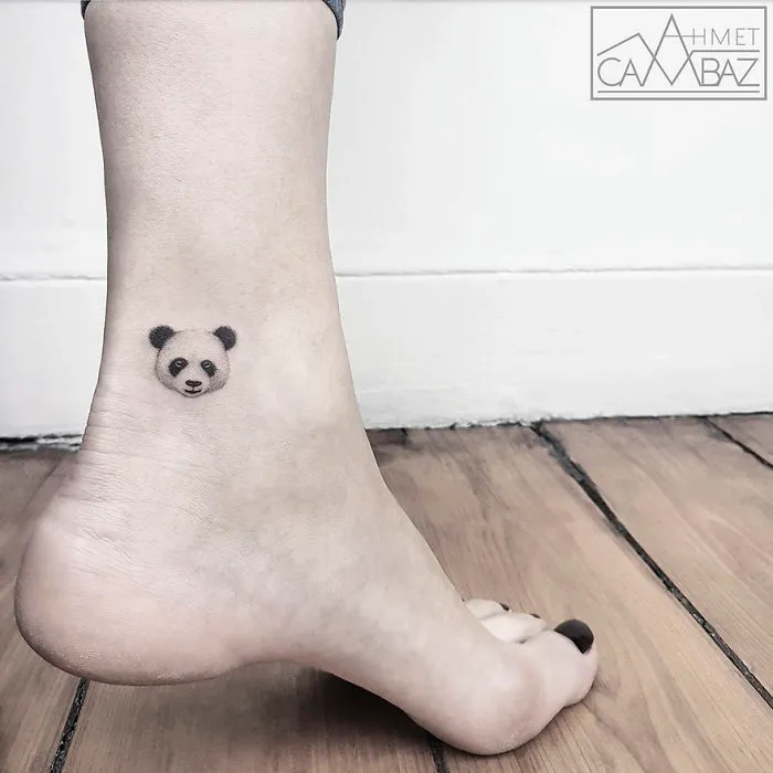 Minimalist panda tattoo on ankle by former Turkish cartoonist, Ahmet Cambaz.