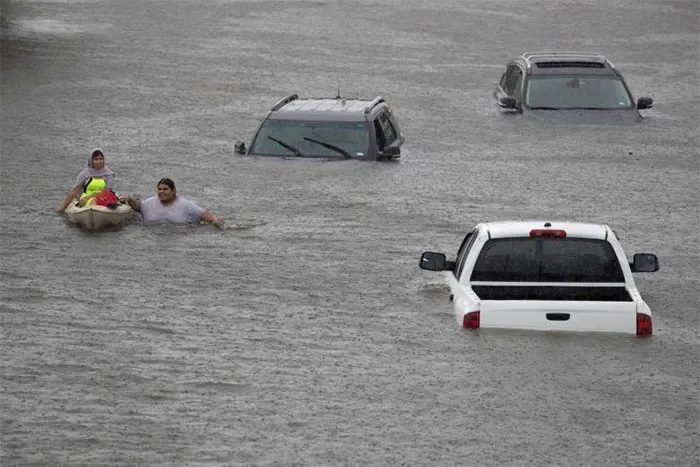 Jesus Rodriguez Rescues Gloria Garcia After Rain Flooded Pearland, In The Outskirts Of Houston