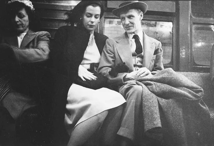 1940s New York subway scene captured by Stanley Kubrick, showcasing passengers in elegant attire.