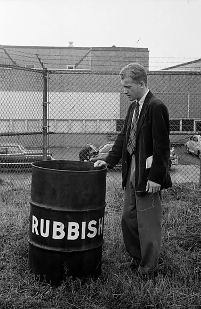 Young man in 1940s New York stands by a rubbish bin, part of Stanley Kubrick's early photography collection.