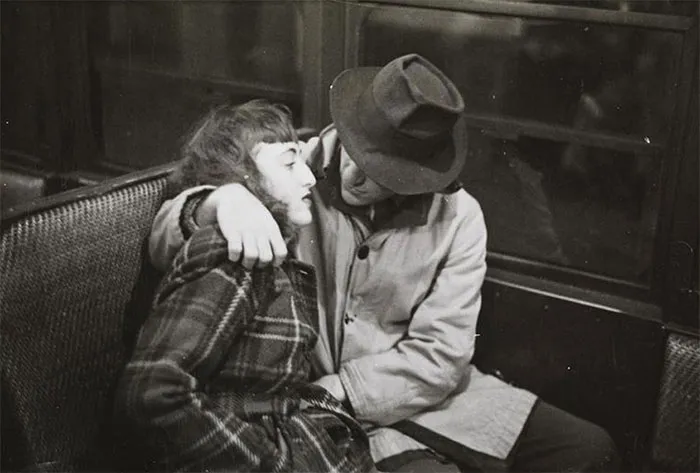 Couple embracing on a 1940s New York train, captured by 17-year-old Stanley Kubrick.