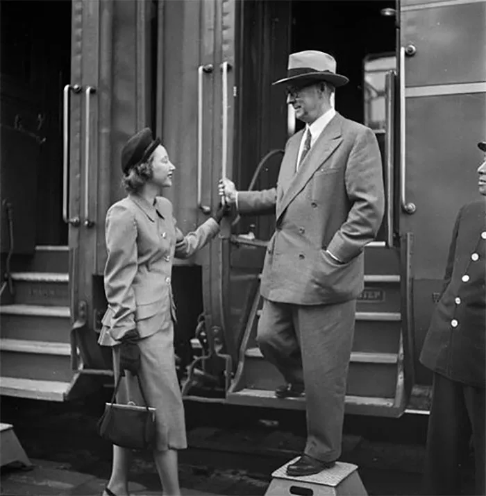 Woman greeting man on a train platform in 1940s New York, showcasing Stanley Kubrick's photography.