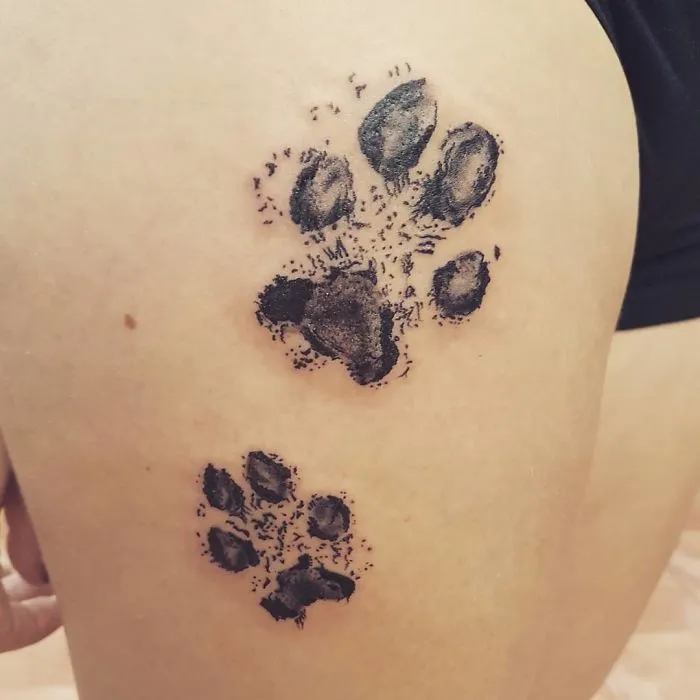 Dog paw print tattoos on skin, showcasing detailed design and creativity.