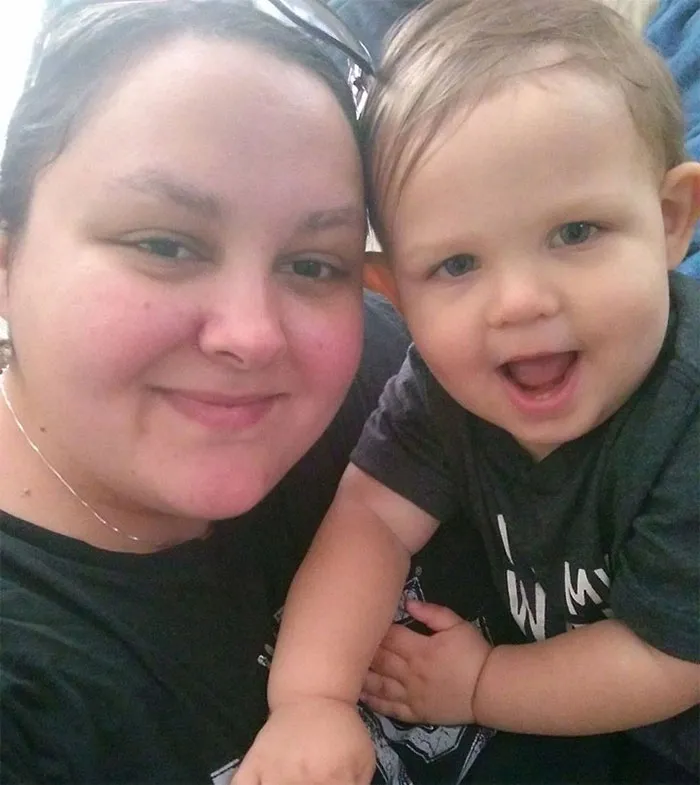 Smiling woman with a child, demonstrating that depression symptoms have no face.