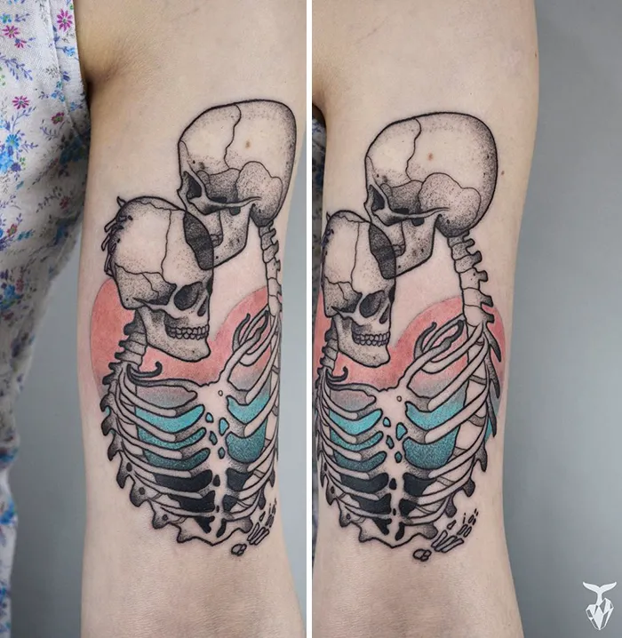 Art Nouveau inspired tattoo of two skeletons embracing with pastel colors on arm.
