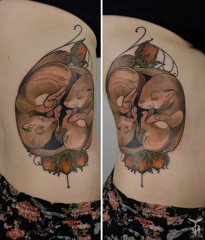 Nature and Art Nouveau inspired tattoo of curled animals on skin.