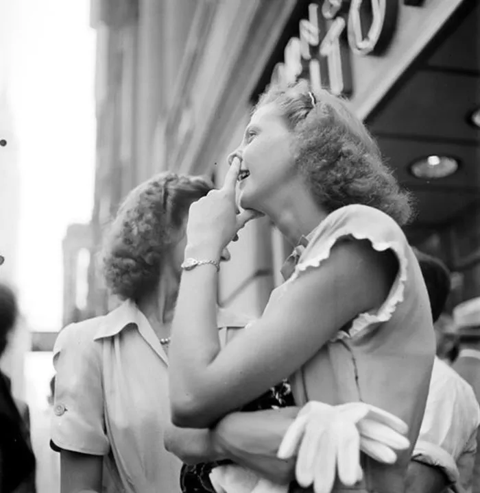 Women chatting on a busy New York street in the 1940s, photographed by young Stanley Kubrick.