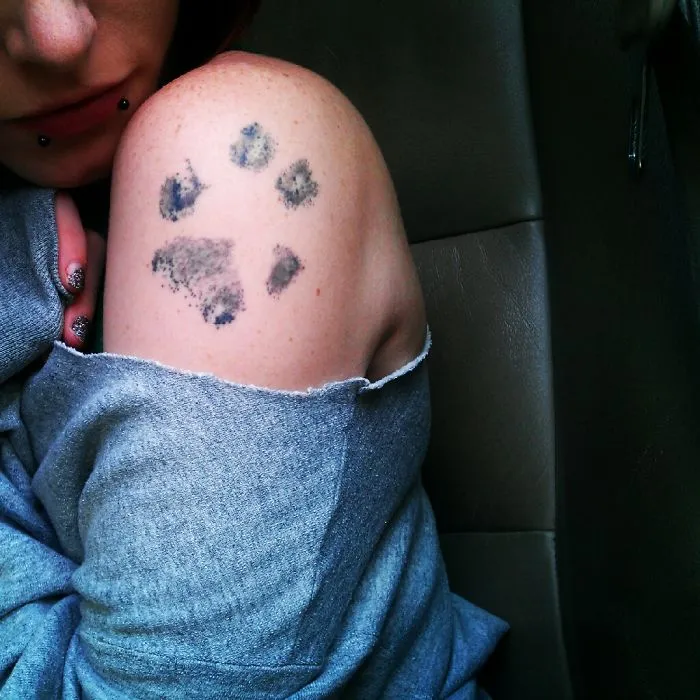 Dog paw print tattoo on a person's shoulder, showcasing unique and creative tattoo art.