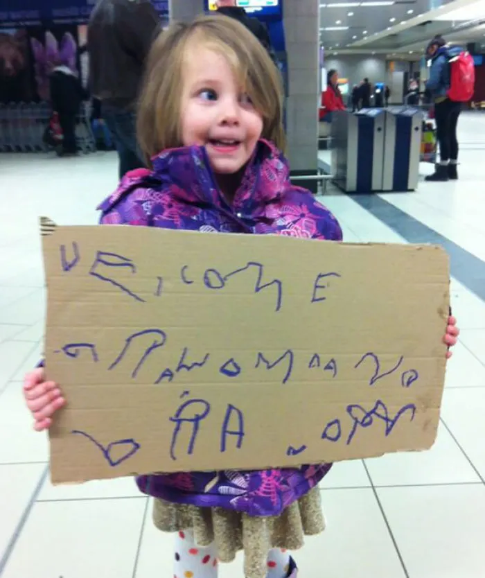 Kid Made An Airport Pickup Sign For Grandma And Grandpa’s Arrival. It’s Getting A Lot Of Smiles At The Airport While We Wait