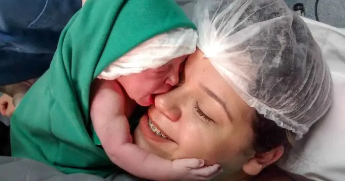 Newborn Girl Clings To Mom's Face Just Seconds After Birth, And The Video Will Warm Your Heart