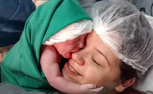 Newborn Girl Clings To Mom's Face Just Seconds After Birth, And The Video Will Warm Your Heart