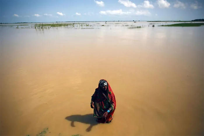 A Flood Victim Washes Herself In Saptari District, Nepal