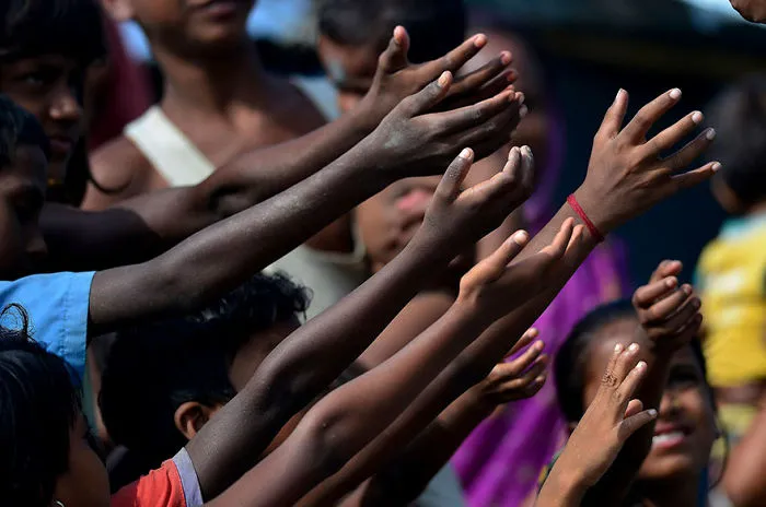 Children Raise Their Hand For Biscuit Packets, Being Distributed By Volunteers At A Hastily Constructed Camp In Assam State Where More Than A Million People Have Lost Their Homes