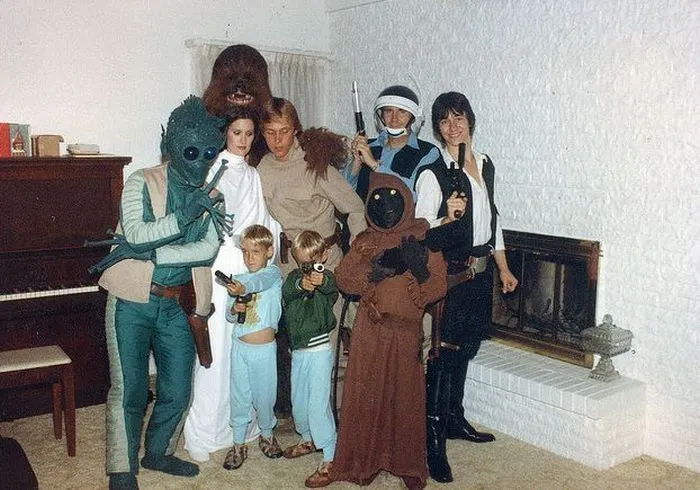 A family dressed in creative Star Wars family Halloween costumes posing together indoors.