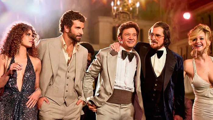 Scene from American Hustle movie showing actors in 1970s attire, perfect for fun facts about movies and movie trivia.