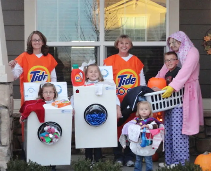 A creative family wearing laundry themed Halloween costumes featuring Tide detergent and washers