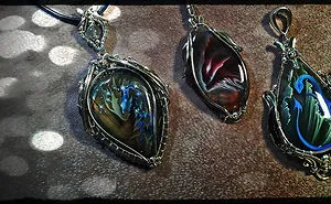The Artist Draws Miniatures On Semi-Precious Stones. Dragons And Other Animals In Unusual Decorations.