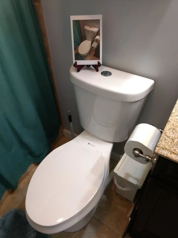 My Wife Keeps A Picture Frame Stand On Top Of The Toilet To Hold Her Phone So She Can Play Music While She's In The Shower. She Should Know Better Than To Leave Me An Opening Like That. Relatives Will Be Here In 20 Minutes