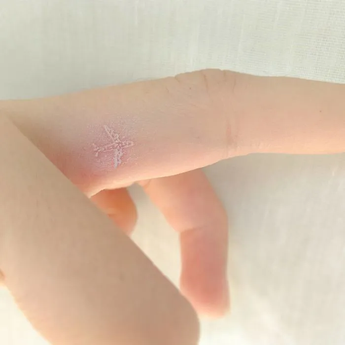 Minimalist airplane travel tattoo on finger, inspiring wanderlust and exploration.
