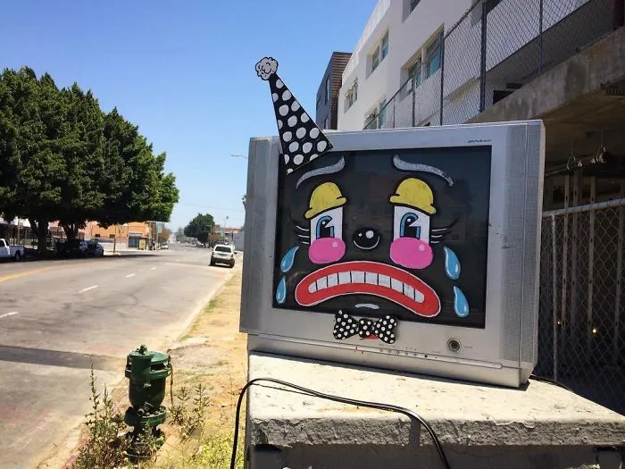Artist Shows The Sorrow Of Thrown Away Objects He Finds In The Streets By Drawing Sad Clown Faces On Them