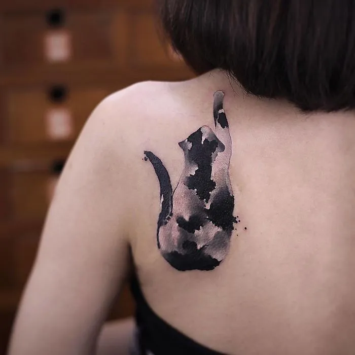Watercolor tattoo of a cat on a person's shoulder by Chen Jie, showcasing artistic and creative ink design.