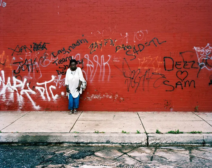 Woman posing on red East Sterner street