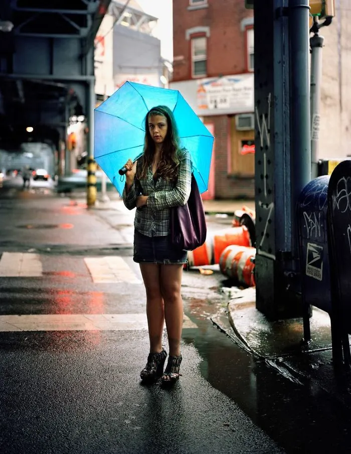 Portrait of Nichol posing with blue umbrella