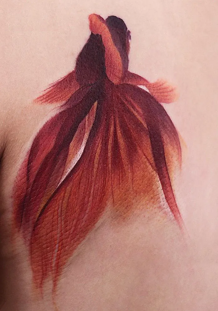Elegant watercolor tattoo of a red betta fish by Chen Jie.