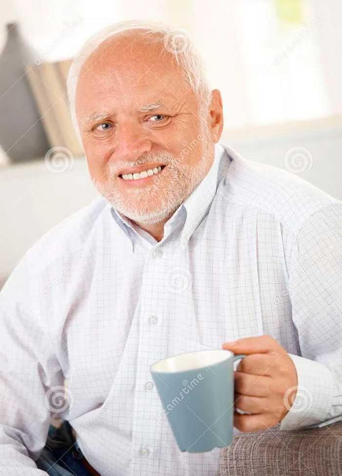 Smiling old man having coffee