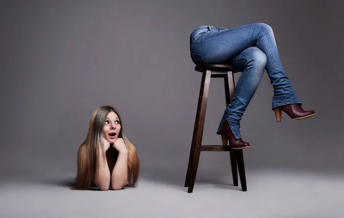 A woman is checking out her ass which has been cut off from the rest of her body