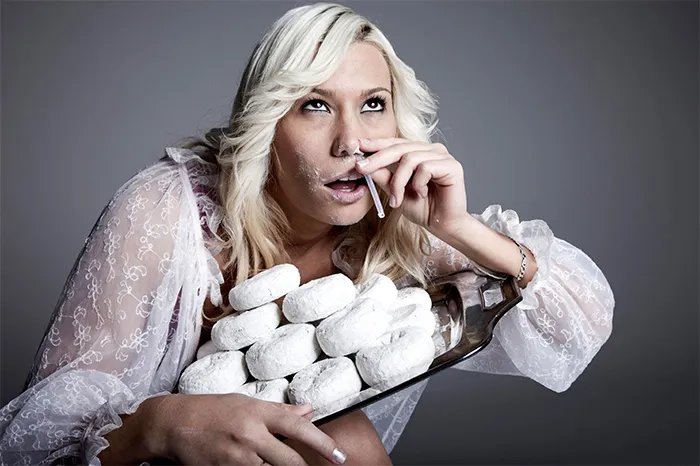 Blond woman snorts donut powder