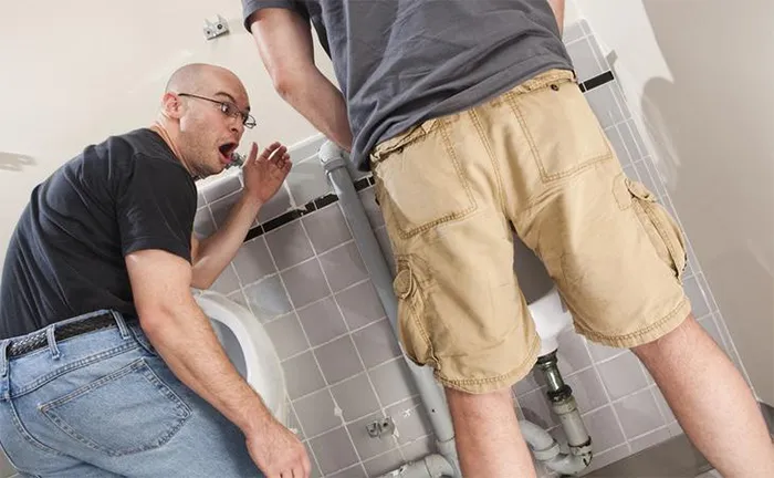 Man is amazed at some guy peeing