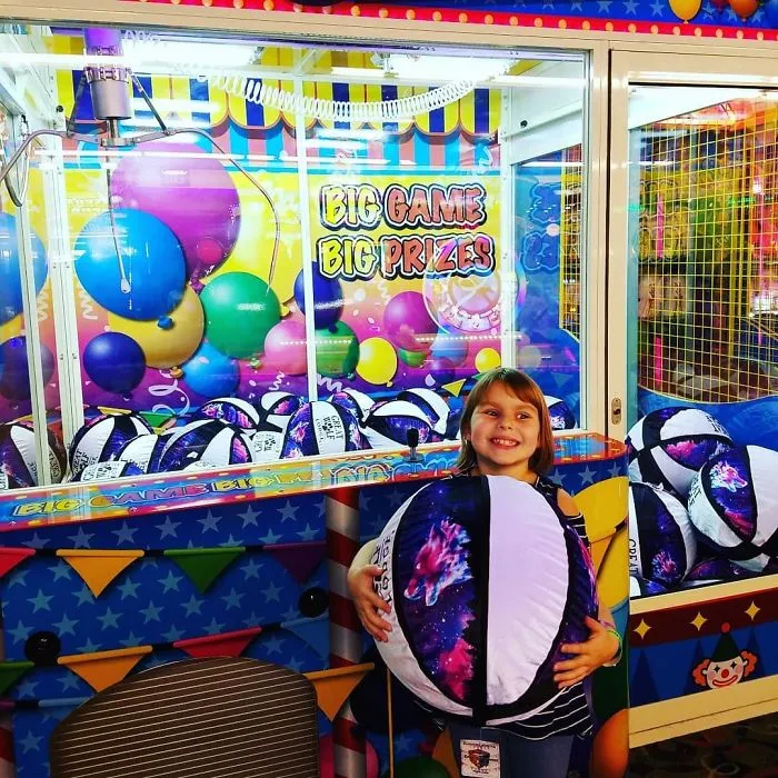 Back At The Arcade, She Wants To Play This Huge Claw Machine, I Say Sure Thinking There Is No Way She Will Get One An I Will Have To Carry That Huge Thing Around. I Was Wrong
