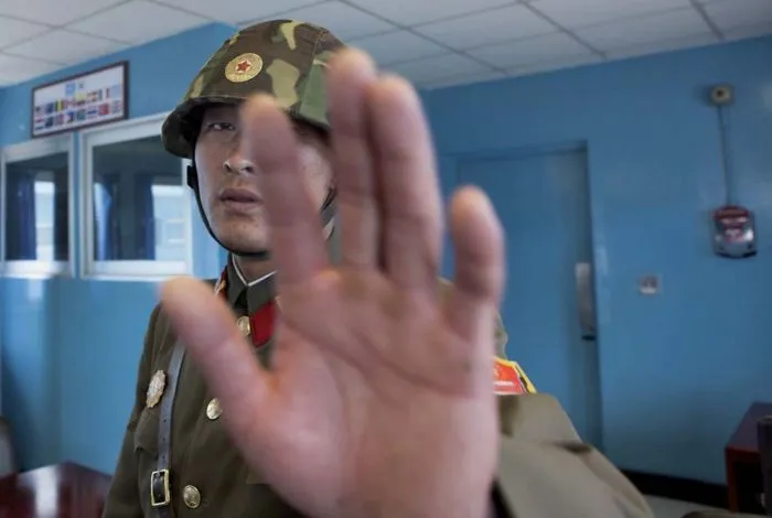 A soldier covering his face with a palm 