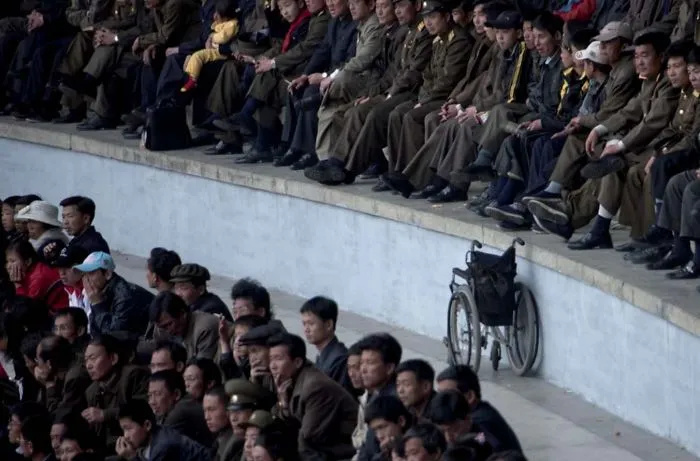A wheelchair on the stadium field with officers 