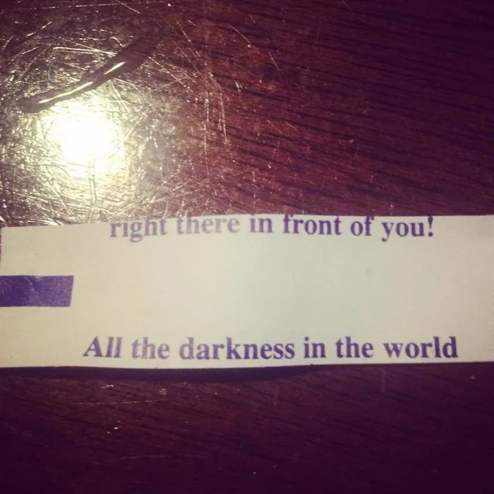 Sassy fortune cookie saying on a wooden table.