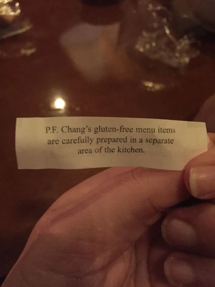 Fortune cookie paper mentioning gluten-free menu preparation details at P.F. Chang's.