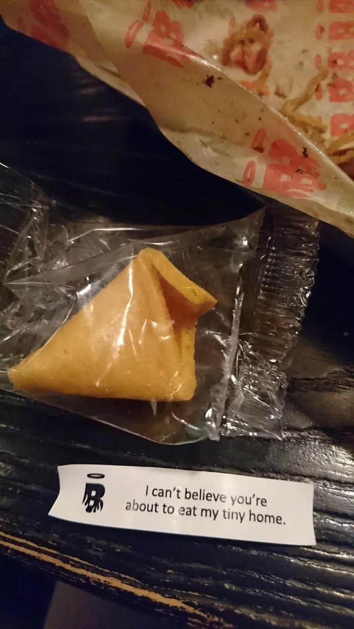 A fortune cookie with a sassy saying: "I can't believe you're about to eat my tiny home."