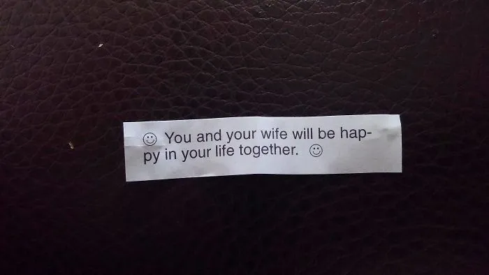 Fortune cookie message predicting happiness for a married couple, with a sassy tone.