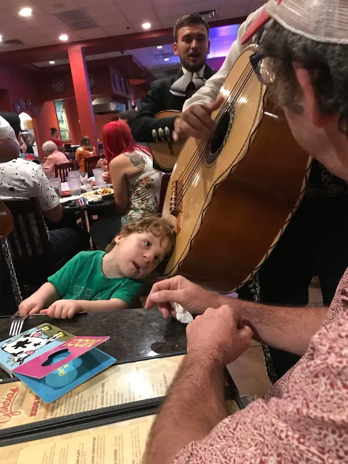 Mi hijo no oye bien, y este mariachi le dejó poner la cabeza en su guitarrón para que pudiera oírlo. ¡Le encantó!