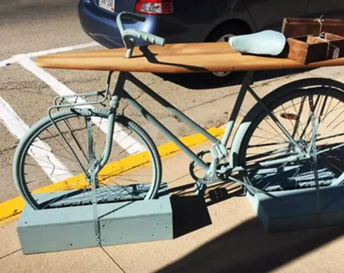 Ever Wanted A Table With Almost No Useable Surface Space That Also Wasn't Level? Bonus, It's Jammed Through The Top Of A Bike That's Held In Place With Plywood Boxes