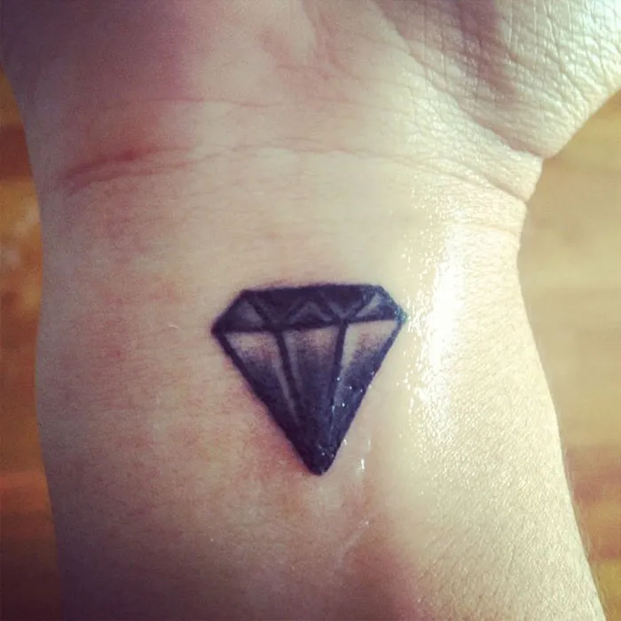 Diamond tattoo on a wrist symbolizing powerful stories and real meaning.