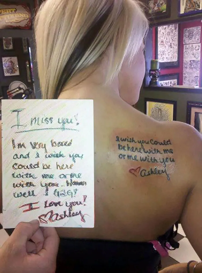 Back tattoo with meaningful story beside handwritten note, expressing love and longing from Ashley.