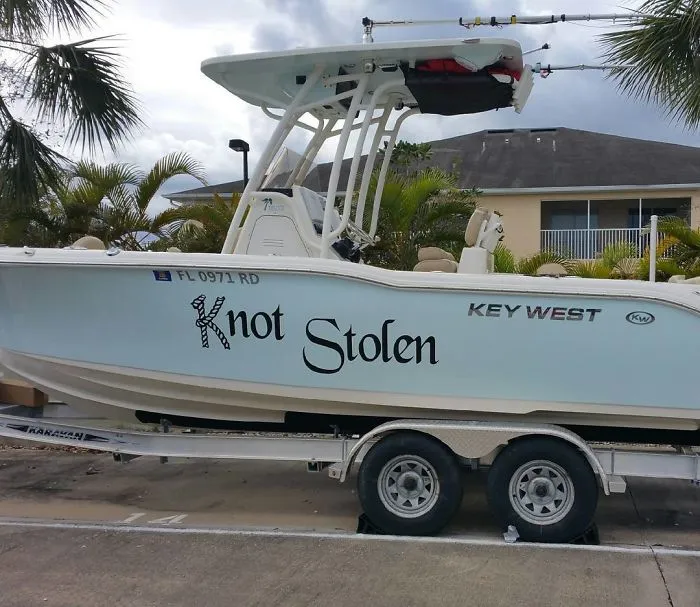 Funny named light blue and white boat in a trailer