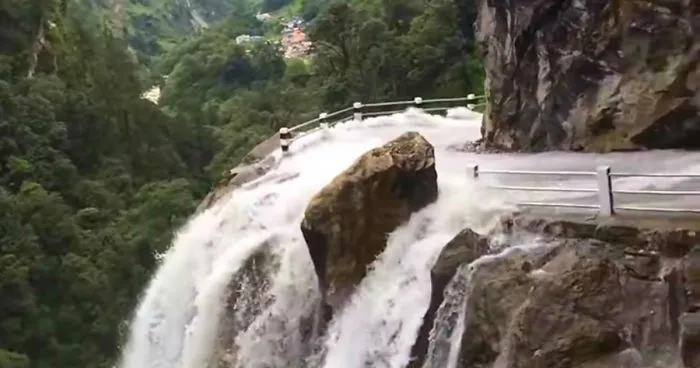 Driver Skillfully Navigates One Of The World's Most Dangerous Roads In Nepal That Runs Through A Waterfall