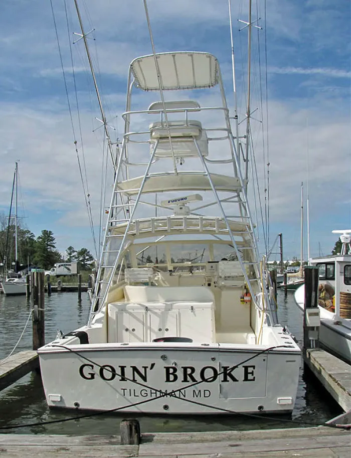 Funny named white boat docked 