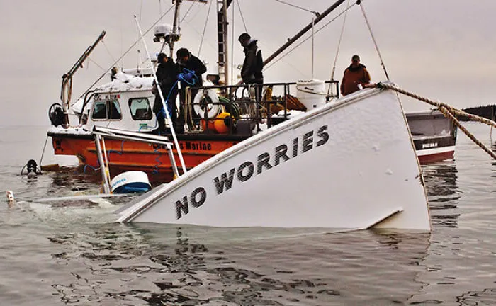 Sinking white boat with a funny name 