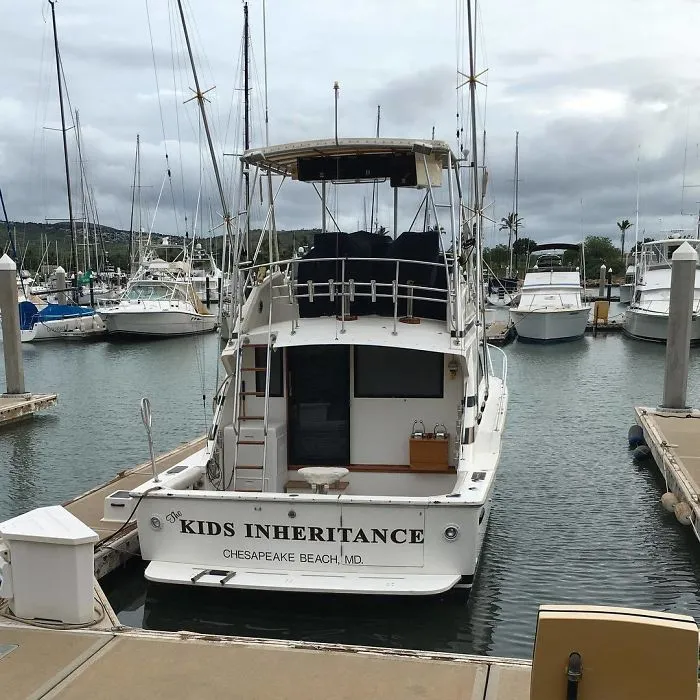 Funny named massive white boat docked 