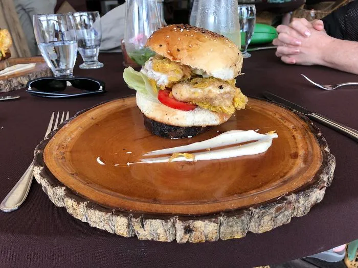 In Belize, My Burger Arrived On A Tiny Wooden Disc On Top Of Another Wooden Slab